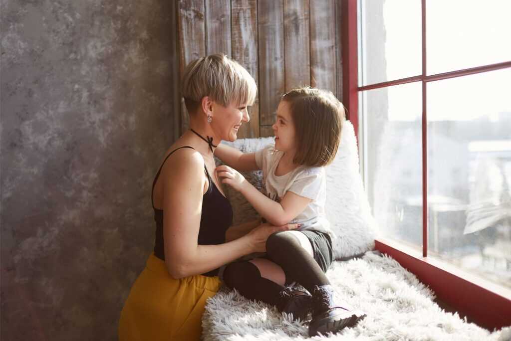 small daughter embracing her mother